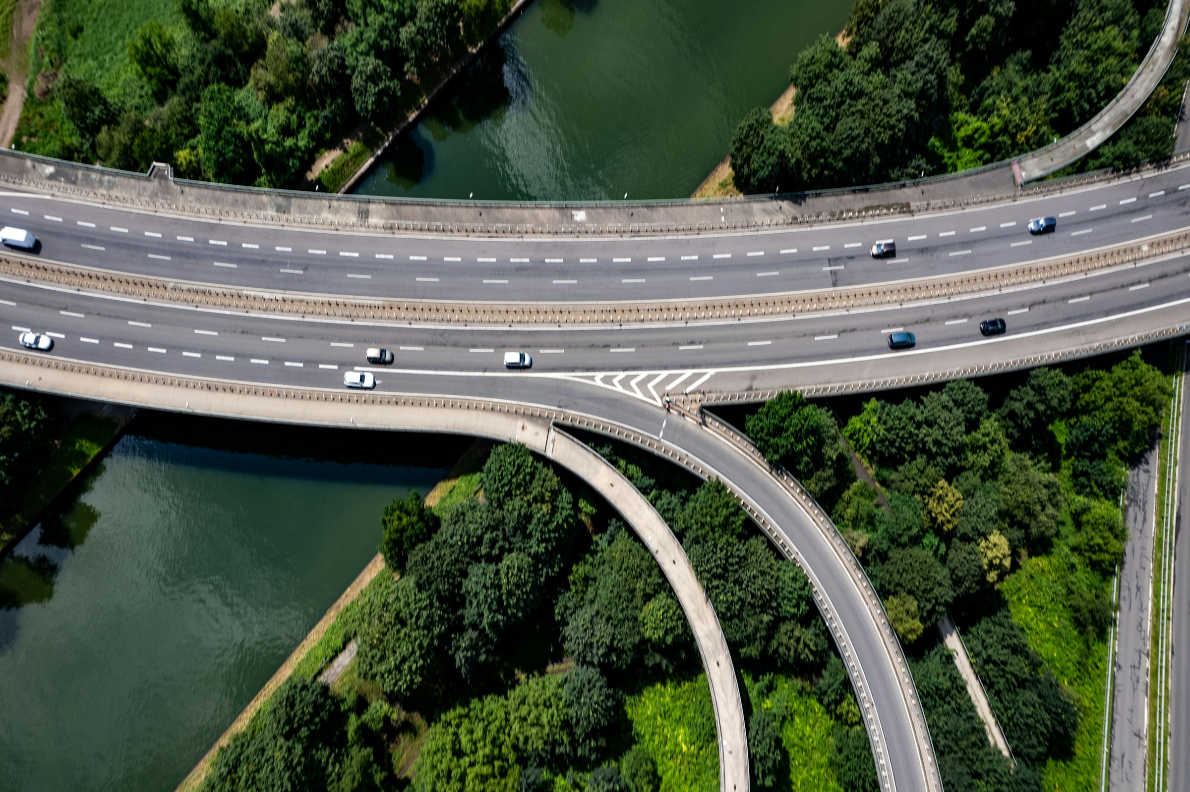 Interconnected roads crossing a river and woodland
